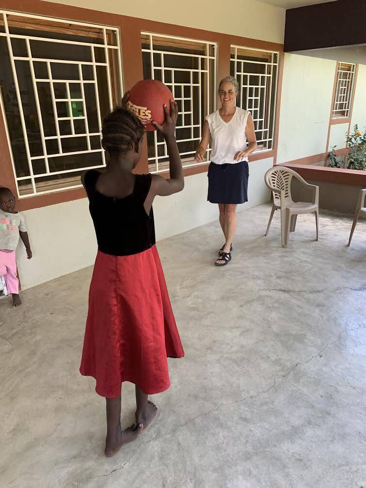 Shelly bounces ball with Aniaka at the Staff Building