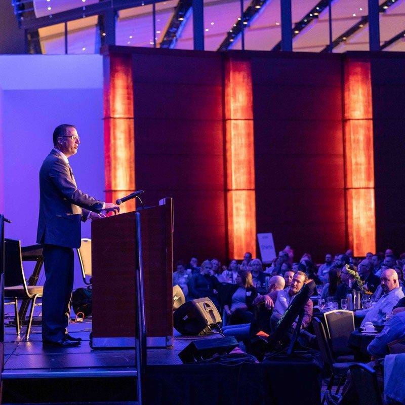 Tim, the founder of Many Hands for Haiti, speaks at an event.